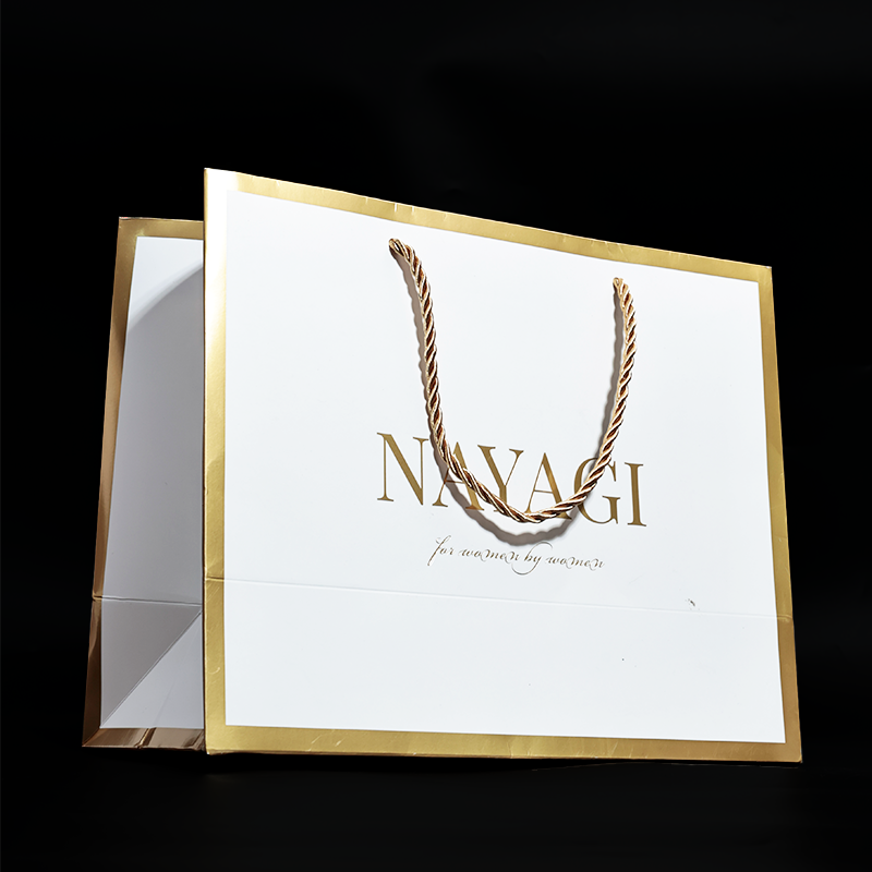 White pattern gold stamped paper bag with gold around the edges