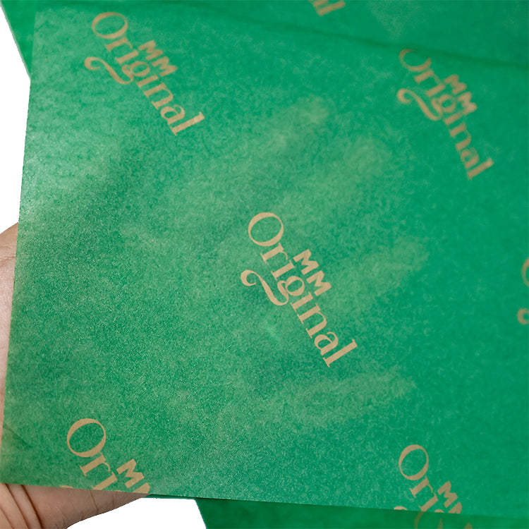 Green wrapping paper pattern with gold foil printing