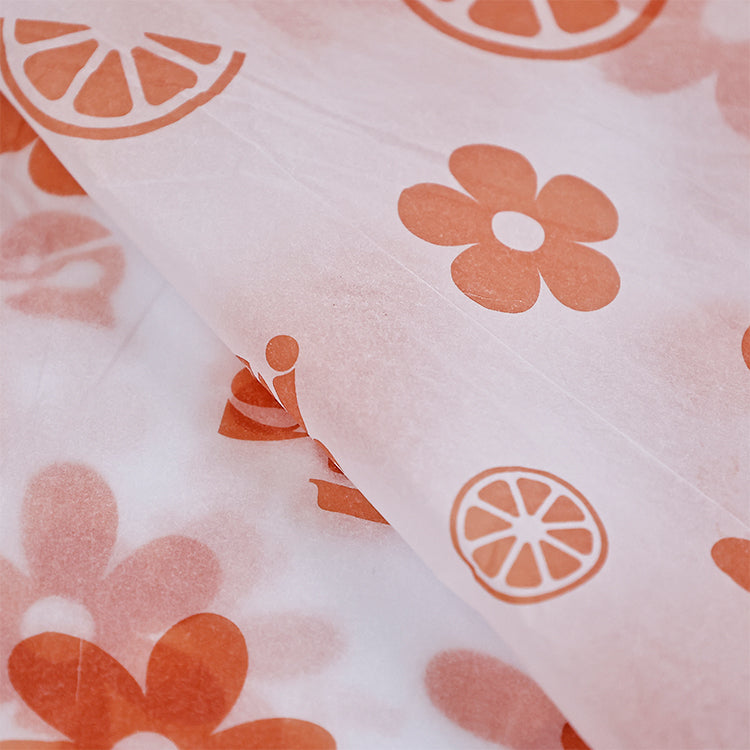 White wrapping paper with multiple patterns and orange printing
