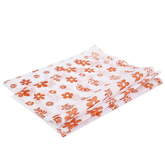 White wrapping paper with multiple patterns and orange printing