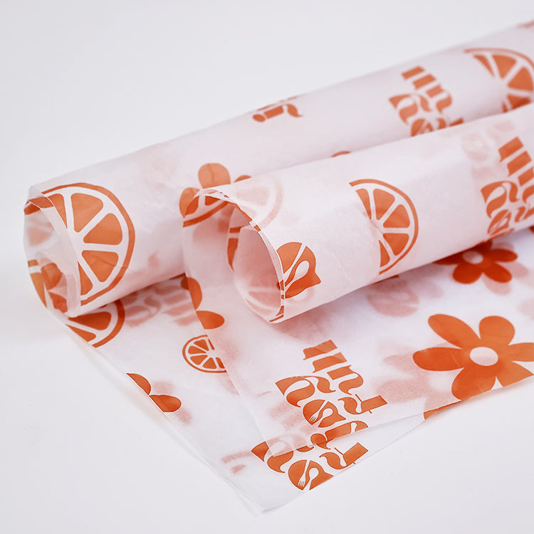 White wrapping paper with multiple patterns and orange printing