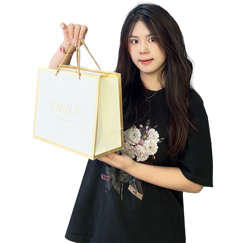 White pattern gold stamped paper bag with gold around the edges